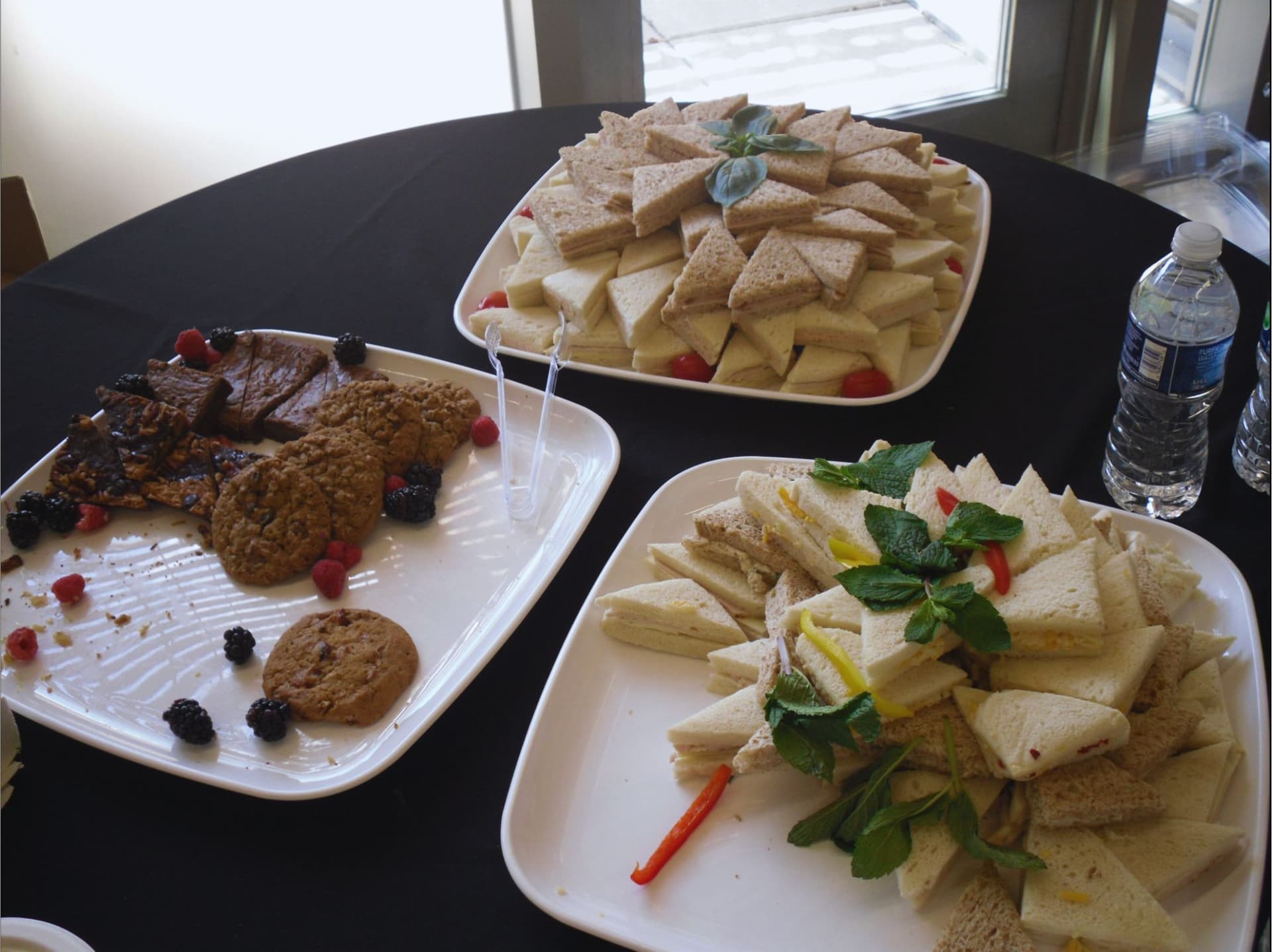 Table of sandwiches, cookies, and snacks